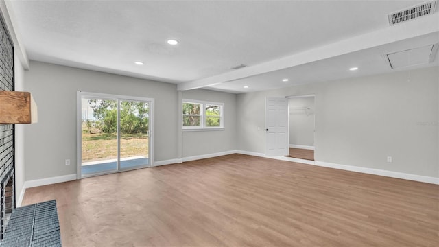 1650 W Mcleod St, Bartow, FL 33830 - unfurnished living room featuring a brick fireplace, recessed lighting, baseboards, attic access, and wood finished floors