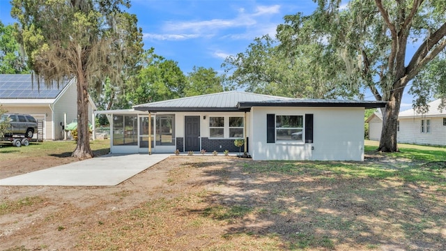 1650 W Mcleod St, Bartow, FL 33830 - back of property with a sunroom, metal roof, concrete block siding, and a yard