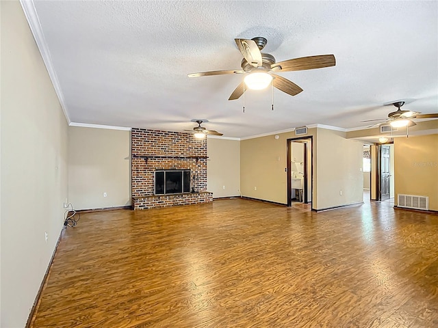 1135 Palace Pl, Lakeland, FL 33813 - unfurnished living room with wood finished floors, crown molding, ceiling fan, a textured ceiling, and a brick fireplace