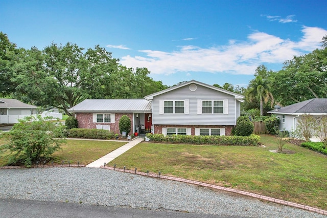 1135 Palace Pl, Lakeland, FL 33813 - split level home featuring brick siding