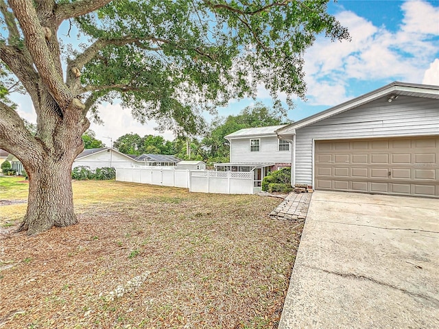 1135 Palace Pl, Lakeland, FL 33813 - view of yard featuring driveway and a garage