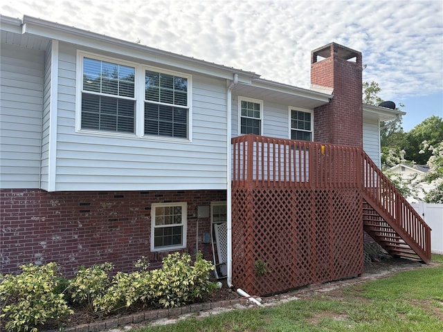1135 Palace Pl, Lakeland, FL 33813 - back of property featuring a chimney, stairway, and a deck