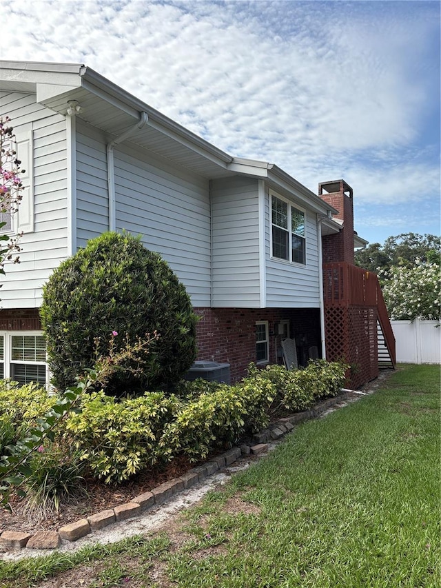 1135 Palace Pl, Lakeland, FL 33813 - view of side of property with brick siding and a chimney