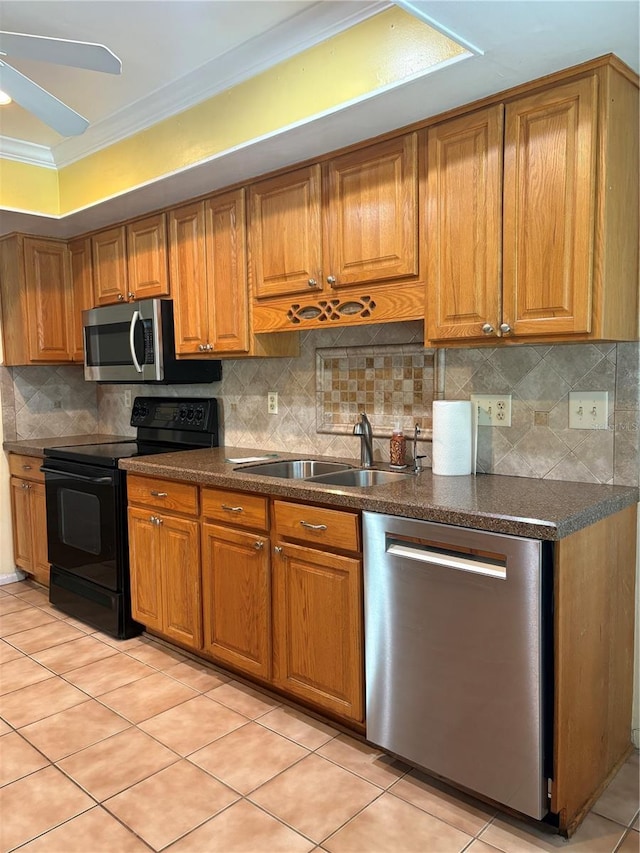1135 Palace Pl, Lakeland, FL 33813 - kitchen with stainless steel appliances, brown cabinets, ornamental molding, and dark countertops