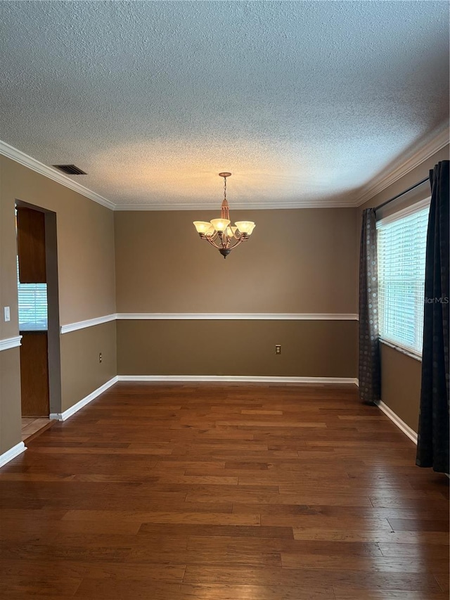 1135 Palace Pl, Lakeland, FL 33813 - spare room featuring a textured ceiling, a chandelier, wood finished floors, and ornamental molding
