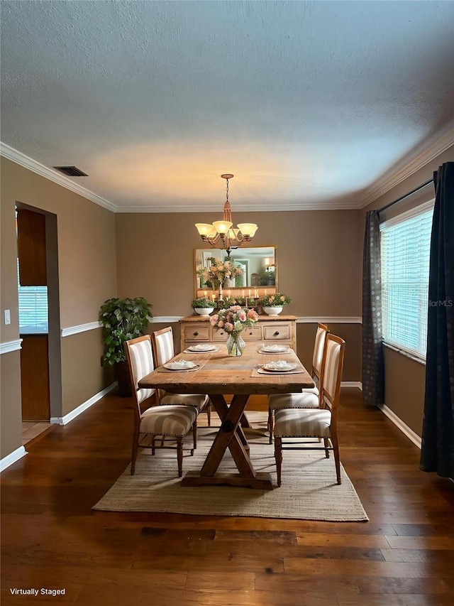 1135 Palace Pl, Lakeland, FL 33813 - dining room with a chandelier, hardwood / wood-style flooring, and crown molding