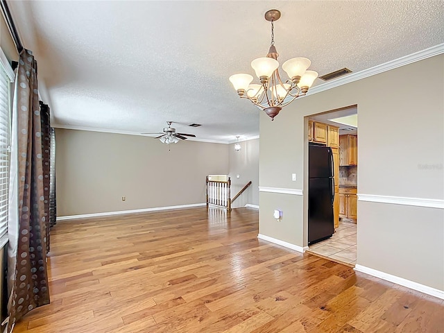 1135 Palace Pl, Lakeland, FL 33813 - spare room featuring ornamental molding, a textured ceiling, a ceiling fan, light wood-type flooring, and a chandelier