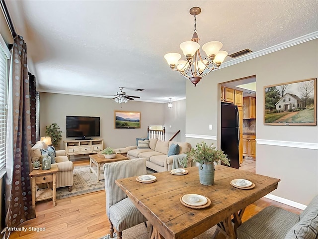 1135 Palace Pl, Lakeland, FL 33813 - dining space with ornamental molding, a chandelier, light wood-type flooring, and ceiling fan