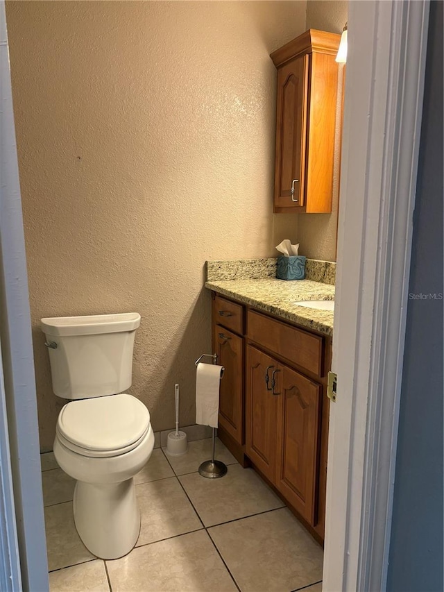 1135 Palace Pl, Lakeland, FL 33813 - bathroom featuring vanity, a textured wall, and tile patterned floors