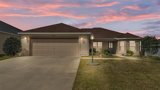 3273 Sennett Cir, Oxford, FL 34484 - ranch-style house featuring a garage, concrete driveway, a front lawn, stucco siding, and a shingled roof