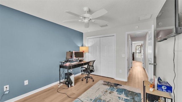 3273 Sennett Cir, Oxford, FL 34484 - office area featuring visible vents, baseboards, ceiling fan, wood finished floors, and attic access