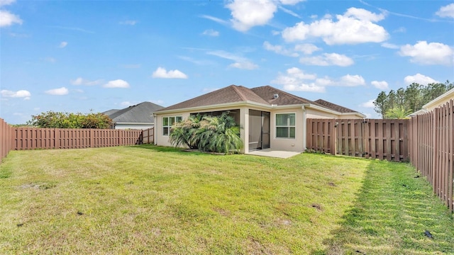 3273 Sennett Cir, Oxford, FL 34484 - back of property featuring a lawn, a fenced backyard, and stucco siding