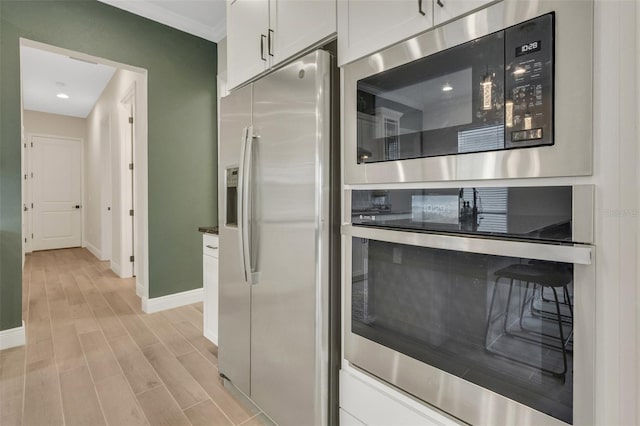 kitchen featuring recessed lighting, light wood-style floors, appliances with stainless steel finishes, and baseboards