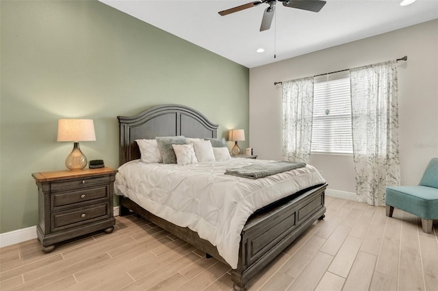 bedroom with light wood finished floors, a ceiling fan, baseboards, and recessed lighting