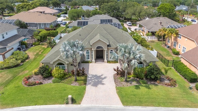 view of front of property featuring decorative driveway and a residential view