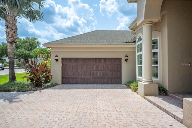 garage with decorative driveway