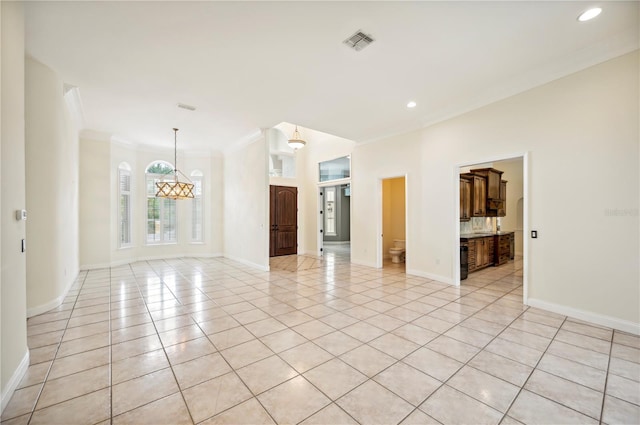 spare room featuring ornamental molding, light tile patterned flooring, baseboards, recessed lighting, and a chandelier