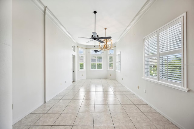 unfurnished dining area with crown molding, ceiling fan, light tile patterned flooring, and baseboards