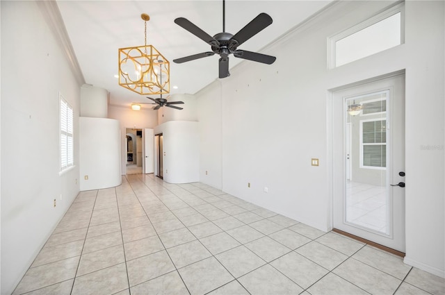 empty room with a ceiling fan, a chandelier, crown molding, and light tile patterned floors