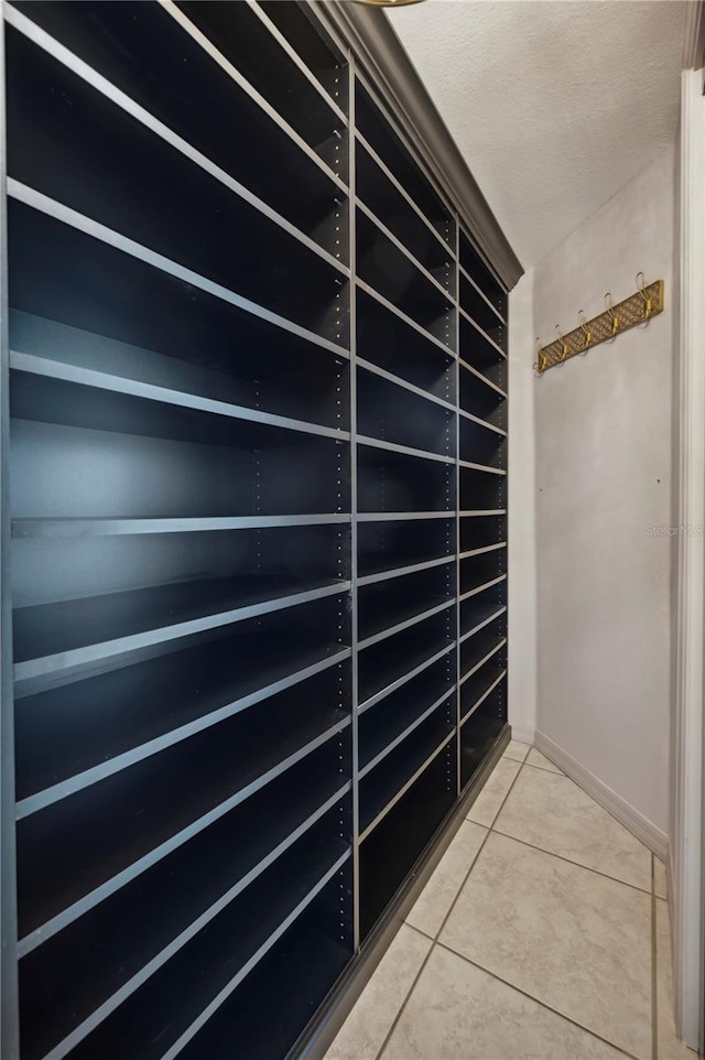 spacious closet with light tile patterned floors