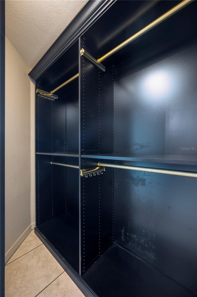 walk in closet with tile patterned flooring