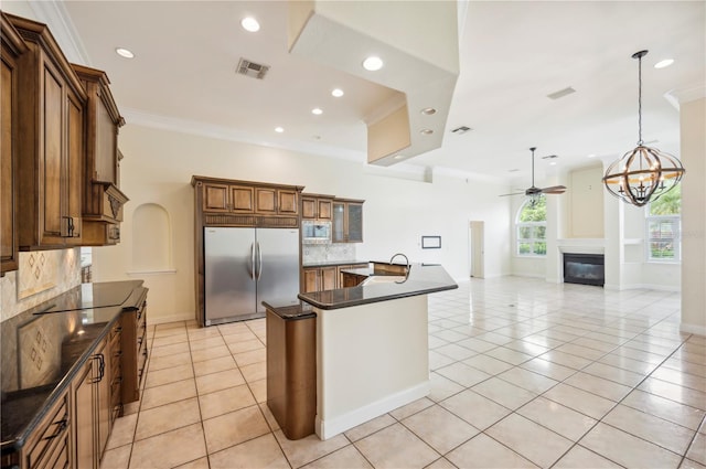 kitchen featuring built in appliances, dark countertops, decorative backsplash, light tile patterned flooring, and crown molding