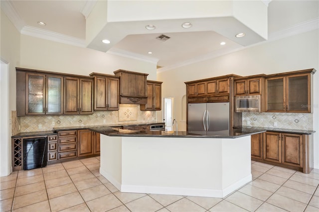 kitchen featuring appliances with stainless steel finishes, light tile patterned floors, decorative backsplash, dark countertops, and ornamental molding