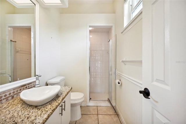 bathroom with a stall shower, toilet, tile patterned floors, and vanity