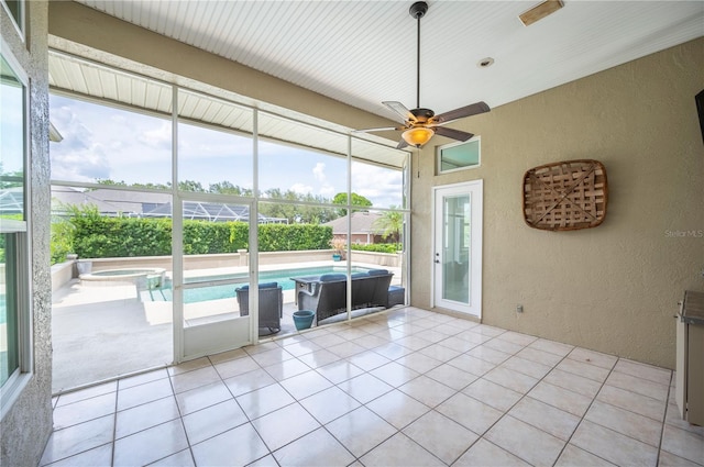 sunroom with ceiling fan and a jacuzzi
