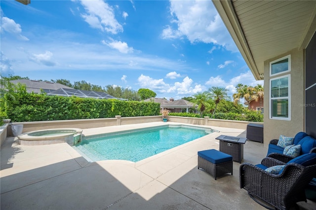 view of swimming pool featuring a patio, a pool with connected hot tub, and outdoor lounge area
