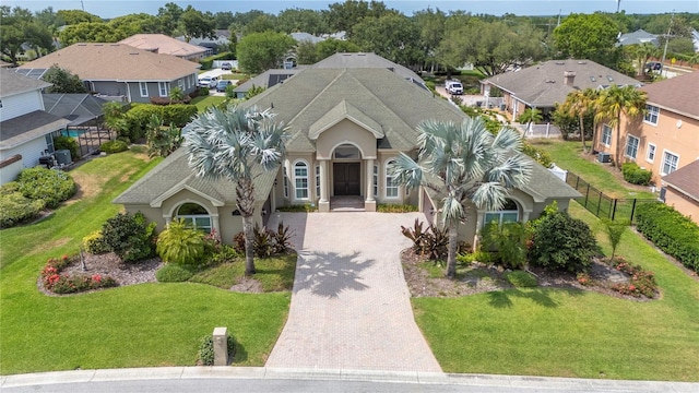 view of front of home featuring decorative driveway, a residential view, and stucco siding