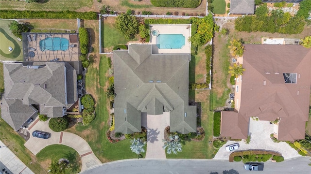 aerial view of property and surrounding area featuring a pool