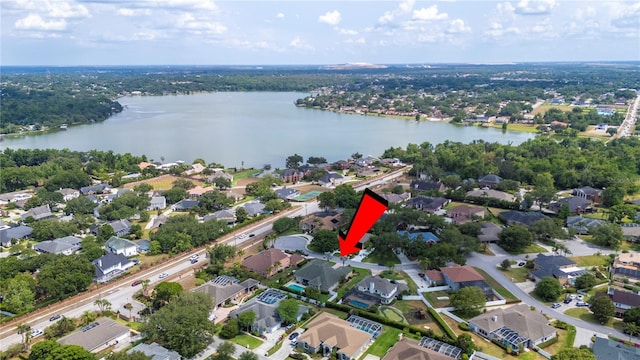 view of property location featuring a large body of water and nearby suburban area