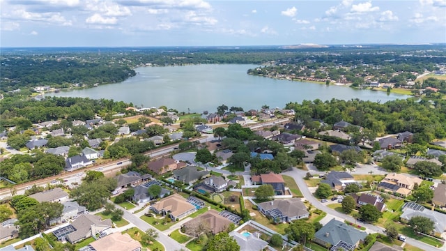 aerial overview of property's location with a nearby body of water and nearby suburban area