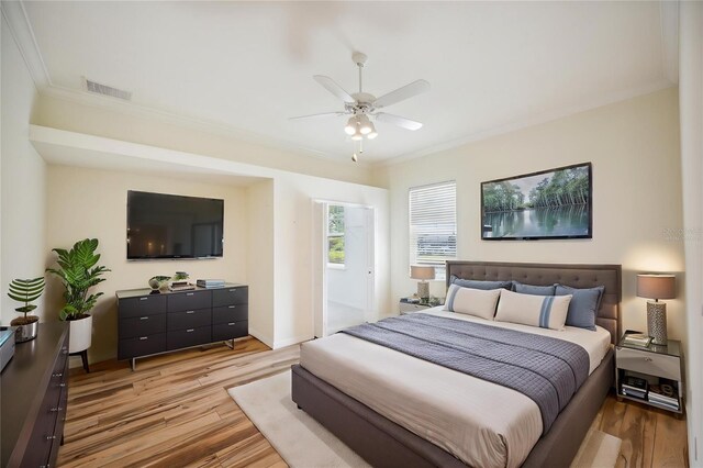 715 Hanover Ct, Lakeland, FL 33813 - bedroom featuring light wood-style flooring, ornamental molding, a ceiling fan, and baseboards