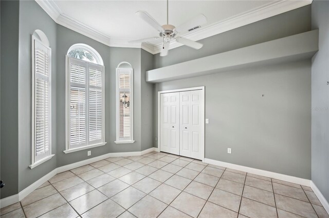 715 Hanover Ct, Lakeland, FL 33813 - unfurnished bedroom featuring ornamental molding, light tile patterned floors, baseboards, a closet, and ceiling fan