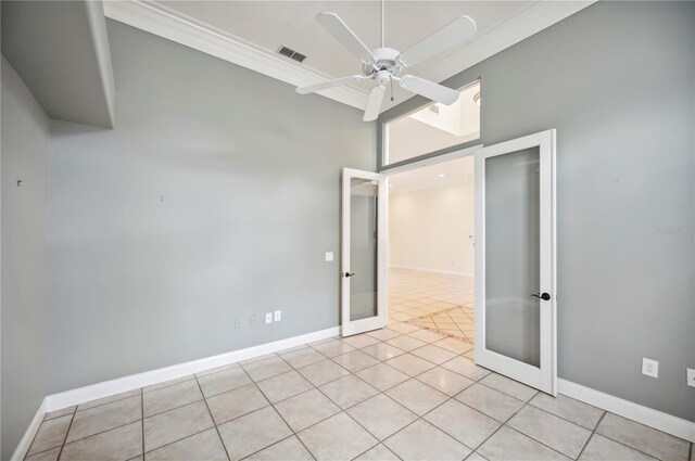715 Hanover Ct, Lakeland, FL 33813 - empty room featuring french doors, a ceiling fan, light tile patterned floors, a towering ceiling, and baseboards