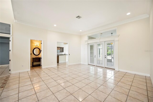 715 Hanover Ct, Lakeland, FL 33813 - unfurnished living room with crown molding, light tile patterned floors, baseboards, french doors, and recessed lighting