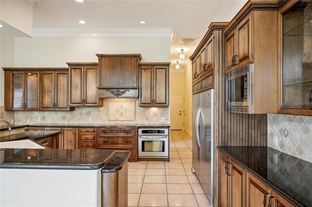 715 Hanover Ct, Lakeland, FL 33813 - kitchen with stainless steel appliances, a sink, tasteful backsplash, light tile patterned flooring, and crown molding