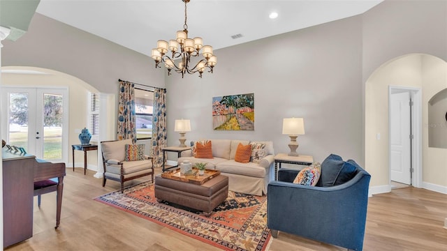 6372 English Creek Dr, Lakeland, FL 33811 - living area featuring arched walkways, light wood finished floors, a chandelier, french doors, and recessed lighting