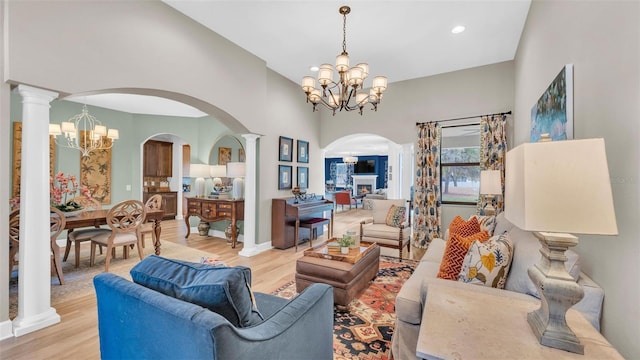 6372 English Creek Dr, Lakeland, FL 33811 - living room with a chandelier, arched walkways, light wood finished floors, recessed lighting, and decorative columns
