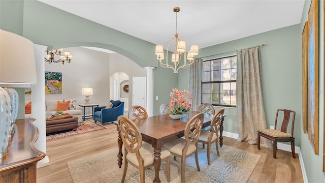 6372 English Creek Dr, Lakeland, FL 33811 - dining room with a chandelier, arched walkways, and wood finished floors