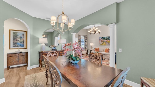 6372 English Creek Dr, Lakeland, FL 33811 - dining room featuring a chandelier, light wood-style floors, and arched walkways