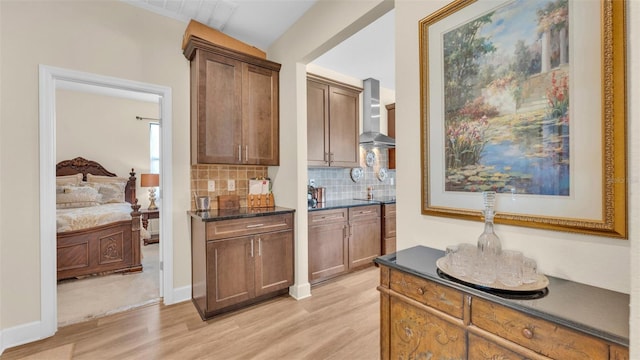 6372 English Creek Dr, Lakeland, FL 33811 - indoor wet bar with wall chimney exhaust hood, light wood-style floors, and decorative backsplash