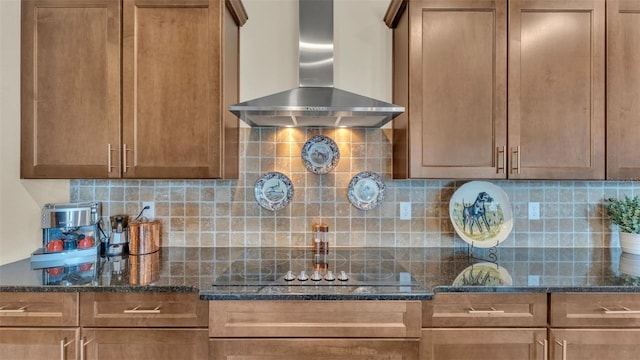 6372 English Creek Dr, Lakeland, FL 33811 - kitchen with wall chimney range hood, black electric cooktop, decorative backsplash, and dark stone counters