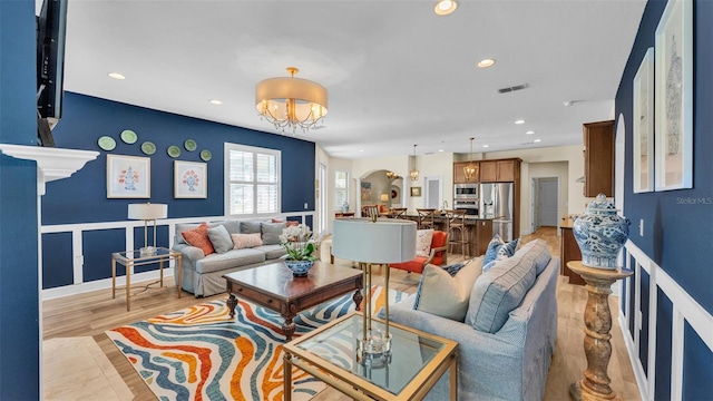6372 English Creek Dr, Lakeland, FL 33811 - living area with arched walkways, recessed lighting, light wood-type flooring, and a chandelier