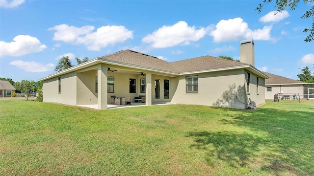 6372 English Creek Dr, Lakeland, FL 33811 - rear view of property featuring a patio, a chimney, a yard, stucco siding, and ceiling fan