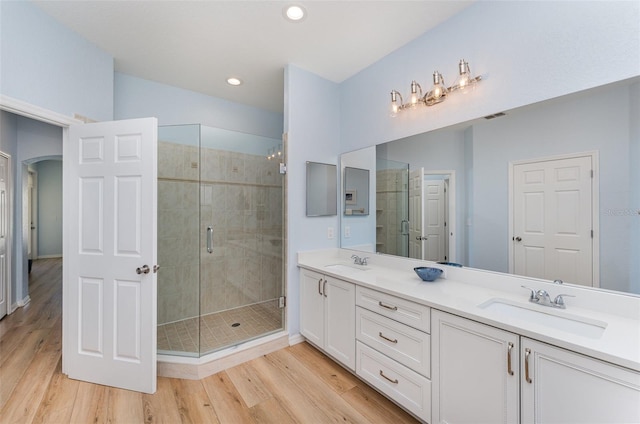 bathroom featuring a sink, a shower stall, and visible vents