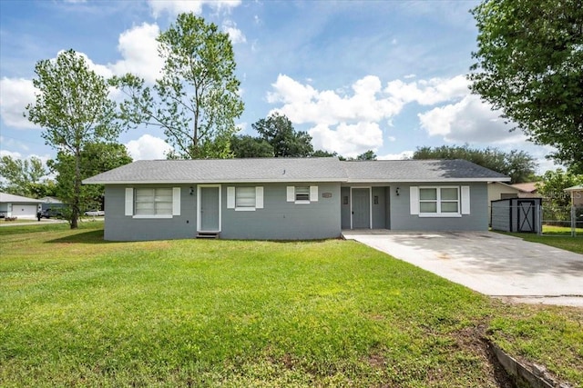 ranch-style home with concrete driveway and a front lawn