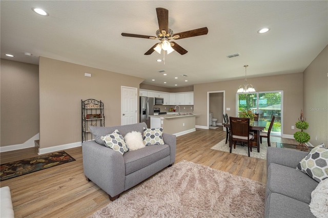 4189 Radford Rd, Bartow, FL 33830 - living room with a chandelier, baseboards, light wood-type flooring, a ceiling fan, and recessed lighting